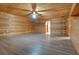 Large living area with wood walls and flooring, and a ceiling fan at 5520 Hearn Rd, Ellenwood, GA 30294