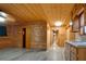 Open living room with wood-paneled walls and ceiling at 5520 Hearn Rd, Ellenwood, GA 30294