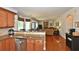 Open kitchen with breakfast bar overlooking Gathering room at 6425 Riley Manor Way, Cumming, GA 30028