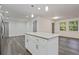 White kitchen island with granite countertop and white shaker cabinets at 8658 Knox Bridge Hwy, Canton, GA 30114