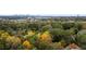 Aerial view of neighborhood with autumn foliage and city skyline at 1013 Lenox Valley Ne Dr, Atlanta, GA 30324