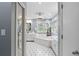 Large bathroom with a corner soaking tub and black and white tile floors at 1013 Lenox Valley Ne Dr, Atlanta, GA 30324