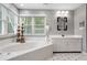 Modern bathroom with a large soaking tub and double vanities at 1013 Lenox Valley Ne Dr, Atlanta, GA 30324