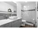 Modern bathroom with gray vanity and subway tile shower at 1013 Lenox Valley Ne Dr, Atlanta, GA 30324