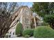 Exterior of charming two-story home with manicured landscaping and three-car garage at 1013 Lenox Valley Ne Dr, Atlanta, GA 30324