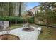 Landscaped backyard with a charming stone fountain at 1013 Lenox Valley Ne Dr, Atlanta, GA 30324