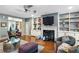 Living room with hardwood floors, fireplace, built-in shelving, and comfortable seating at 1013 Lenox Valley Ne Dr, Atlanta, GA 30324