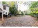 Gravel backyard with trees and some leaves at 1252 Mclendon Ne Ave, Atlanta, GA 30307