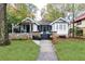 Charming white bungalow with stone accents and a welcoming front porch at 1252 Mclendon Ne Ave, Atlanta, GA 30307