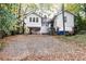 Back of house, gravel driveway, and trees at 1252 Mclendon Ne Ave, Atlanta, GA 30307