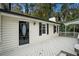 Home exterior featuring a deck and black front door at 2088 E Cherokee Dr, Woodstock, GA 30188