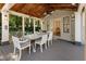 Covered patio features an outdoor dining area and ceiling fan at 315 Brandenburgh Cir, Roswell, GA 30075