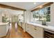 Modern kitchen with white cabinets, quartz countertops, and hardwood floors at 315 Brandenburgh Cir, Roswell, GA 30075