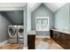 Laundry room with built-in cabinets and tile flooring at 315 Brandenburgh Cir, Roswell, GA 30075