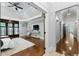 Main bedroom with hardwood floors, tray ceiling, sitting area, and large windows at 315 Brandenburgh Cir, Roswell, GA 30075