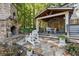 Stone patio with a fireplace and comfortable seating area at 315 Brandenburgh Cir, Roswell, GA 30075