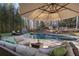 Comfortable patio furniture under an umbrella near the pool at 315 Brandenburgh Cir, Roswell, GA 30075