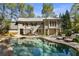 Stunning pool with expansive stone patio and lounge chairs at 315 Brandenburgh Cir, Roswell, GA 30075