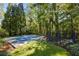 Private backyard with sports court, trampoline, and lush trees at 315 Brandenburgh Cir, Roswell, GA 30075