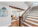 Stunning staircase with dark wood railings and hardwood floors at 315 Brandenburgh Cir, Roswell, GA 30075