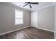 Spacious bedroom with ceiling fan and wood-look flooring at 1048 Abercorn Way, Douglasville, GA 30134