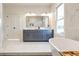 Modern bathroom boasts double vanity, soaking tub, and marble tile at 1103 Church Nw St, Atlanta, GA 30318