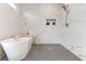 Elegant bathroom with marble shower, soaking tub, and gray hex tile floor at 1103 Church Nw St, Atlanta, GA 30318