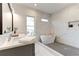Spa-like bathroom with soaking tub, double vanity, and marble accents at 1103 Church Nw St, Atlanta, GA 30318