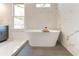 Relaxing bathroom featuring a freestanding tub and marble tile at 1103 Church Nw St, Atlanta, GA 30318