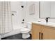 Clean bathroom with white subway tile, a shower/tub combo, and wood vanity at 1103 Church Nw St, Atlanta, GA 30318