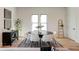 Modern dining room features round table, neutral chairs, and hardwood floors at 1103 Church Nw St, Atlanta, GA 30318