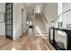 Hardwood floor entryway with staircase and black French doors at 1103 Church Nw St, Atlanta, GA 30318