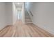 Long hallway with light hardwood floors and staircase at 1103 Church Nw St, Atlanta, GA 30318