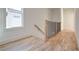 Light-filled hallway with hardwood floors and modern railing at 1103 Church Nw St, Atlanta, GA 30318