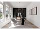 Modern home office with dark accent wall, hardwood floors, and large windows at 1103 Church Nw St, Atlanta, GA 30318