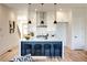 Eat-in kitchen with island seating, white shaker cabinets, and hardwood floors at 1103 Church Nw St, Atlanta, GA 30318