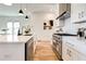 Modern kitchen with white cabinets, quartz countertops, and stainless steel appliances at 1103 Church Nw St, Atlanta, GA 30318