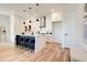 Open concept kitchen island with seating, white cabinets and hardwood floors at 1103 Church Nw St, Atlanta, GA 30318