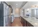 Modern kitchen with dark cabinets, granite counters, and stainless steel appliances at 2411 Oakleaf Cir, Lithonia, GA 30058