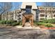 Inviting condo building entrance with stone accents and covered walkway at 1214 Highland Bluff Se Dr # 214, Atlanta, GA 30339