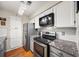 Updated kitchen featuring stainless steel appliances and granite countertops at 1214 Highland Bluff Se Dr # 214, Atlanta, GA 30339