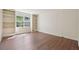 Spacious bedroom with hardwood floors and built-in shelves at 174 Amherst Pl, Atlanta, GA 30327