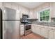 Stainless steel appliances and granite countertops in this kitchen at 174 Amherst Pl, Atlanta, GA 30327