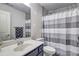 Bathroom featuring a single sink vanity and shower with striped curtain at 4233 Creekrun Cir, Buford, GA 30519