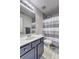 Bathroom featuring a single sink vanity, toilet and shower with gray striped curtain at 4233 Creekrun Cir, Buford, GA 30519