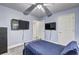 Bedroom with two TVs, a ceiling fan and carpeted floors at 4233 Creekrun Cir, Buford, GA 30519