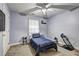 Light blue bedroom with a ceiling fan and carpeted floor with a single bed at 4233 Creekrun Cir, Buford, GA 30519