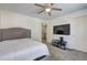 Bright bedroom showcasing a comfortable bed, entertainment center, and a ceiling fan at 4233 Creekrun Cir, Buford, GA 30519
