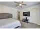 A well-lit bedroom featuring a large window, soft carpet, and a ceiling fan for added comfort at 4233 Creekrun Cir, Buford, GA 30519
