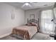 Bedroom with carpeted floors, updated light fixture and decorative wall art at 4233 Creekrun Cir, Buford, GA 30519